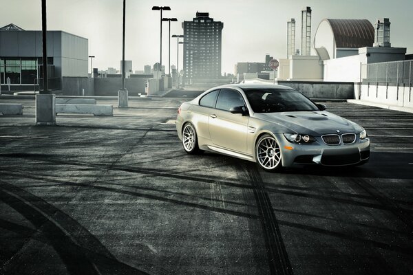 There is a silver BMW on a black and white background