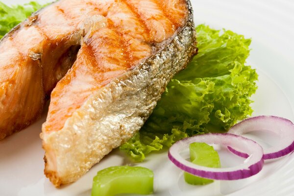 Baked fish steak on a cabbage leaf