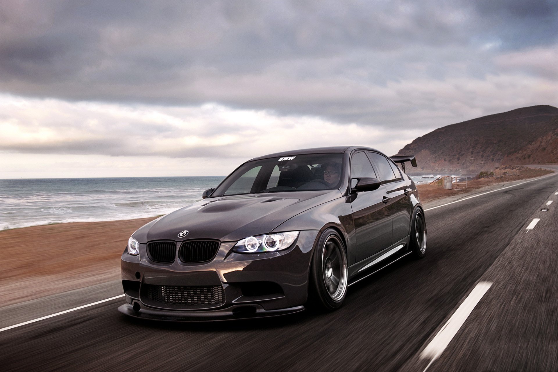 bmw 3 series 335i e90 black front bmw sea beach road speed