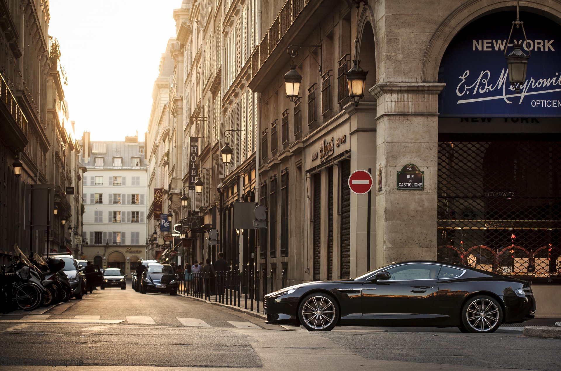 aston martin virage turn a side view street building