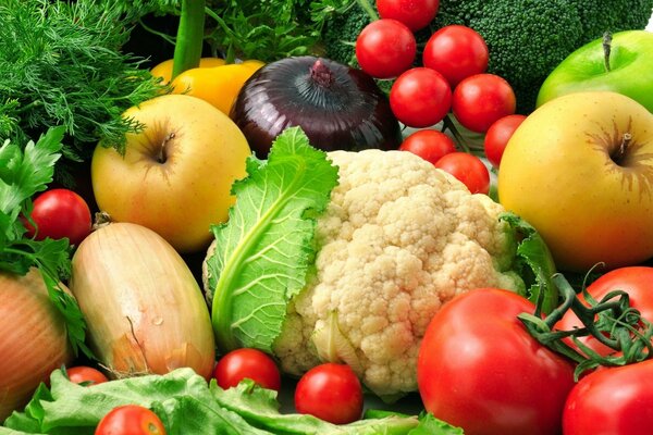 Vegetables and fruits on a background of greenery