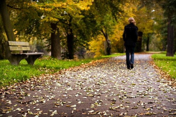 A girl walking in an autumn park