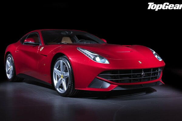 El Ferrari F12 berlinetta rojo se encuentra en la penumbra