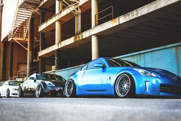 A blue Nissan parked in the industrial zone