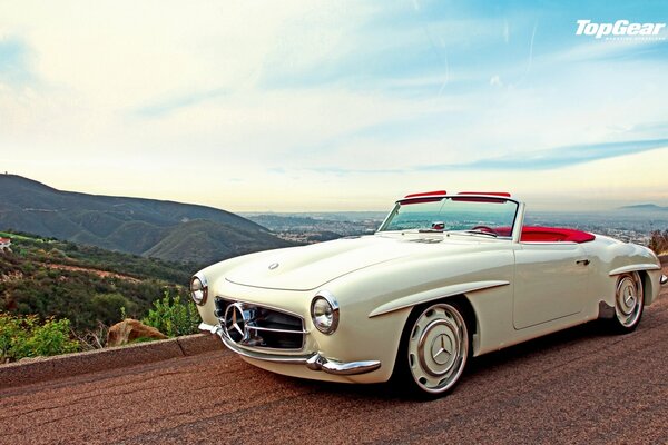 Top gear white Mercedes Benz on the background of an endless landscape