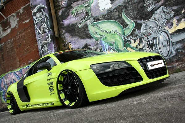 A new tuned Audi stands in front of graffiti
