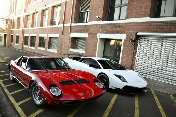 Lamborghini and murcielago are standing next to each other in the parking lot at the house