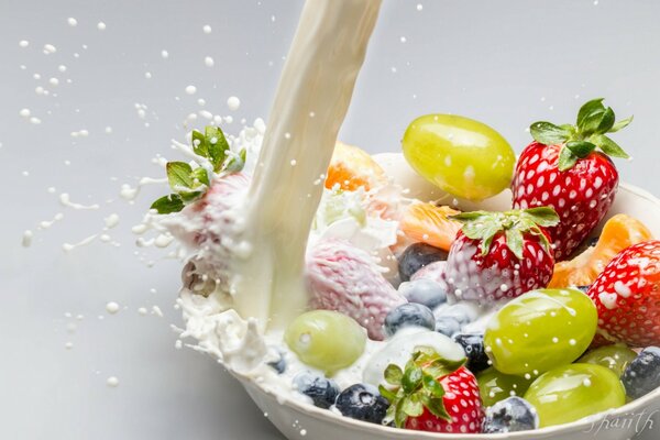 Fruits and berries are poured with milk