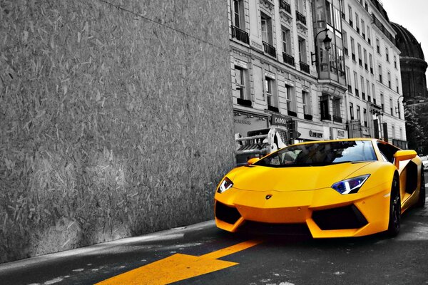 Lamborghini amarillo en la carretera en la ciudad en blanco y negro