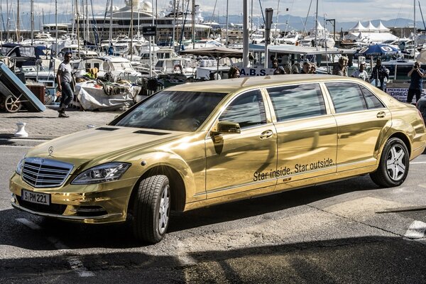 Golden metal Mercedes Benz car at the car wash
