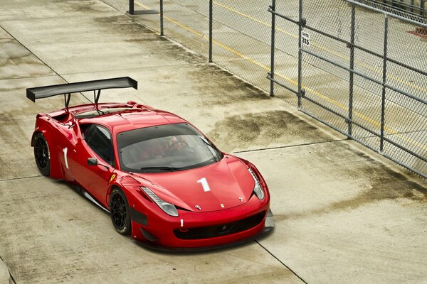 Red ferrari on the fence background