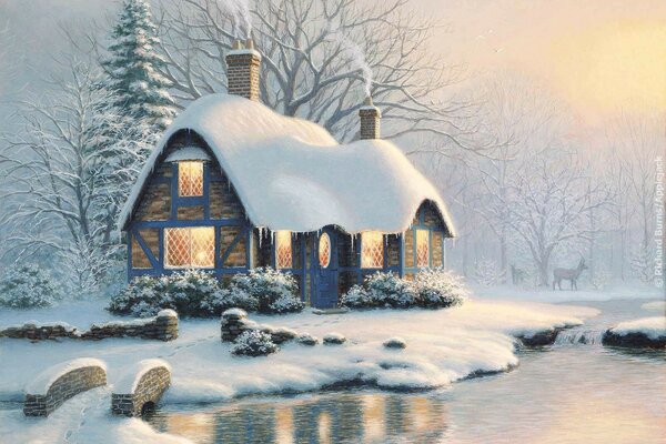 Casa en la nieve en la orilla del río