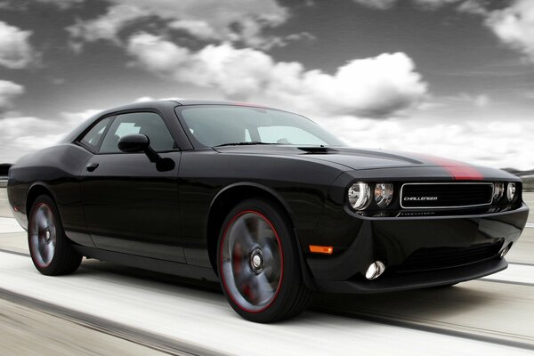 Beautiful Dodge challenger muscle car against the sky and clouds