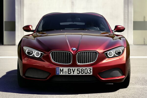 A red foreign car poses in the sun