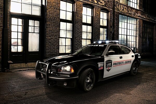 Muscul police car at night at the building