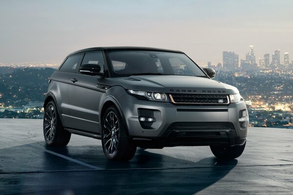 Grey range rover on the background of the city front view