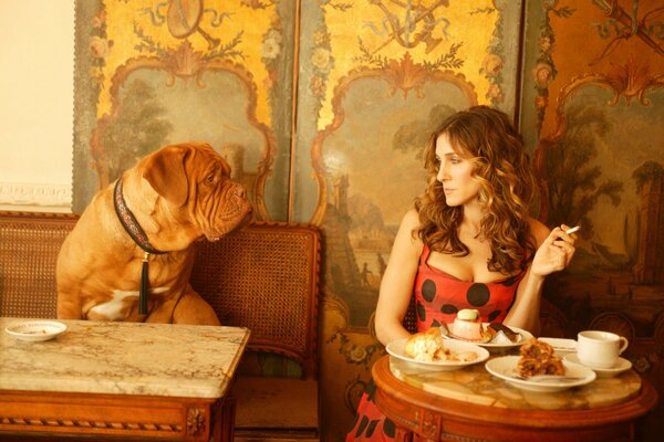 A dog and a girl at tables in a cafe