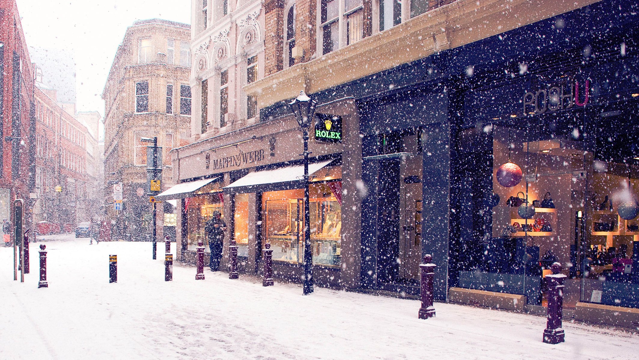 the city snow stores winter europe street