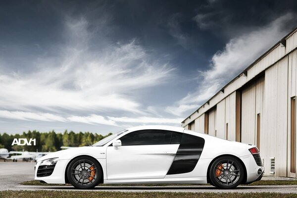 White Audi supercar on the background of the hangar