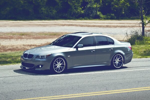 A tuned grey BMW on the road