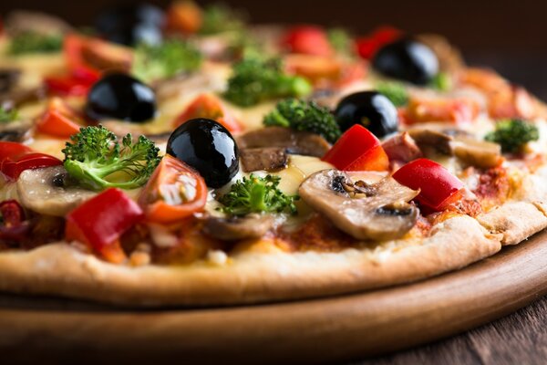Hot pizza with mushrooms, olives and parsley