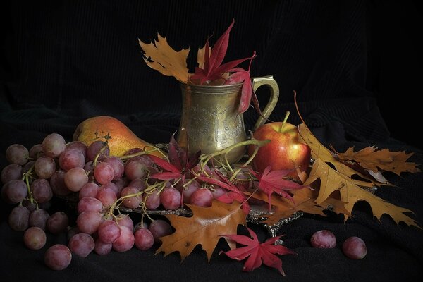 Autumn still life with fruits and foliage