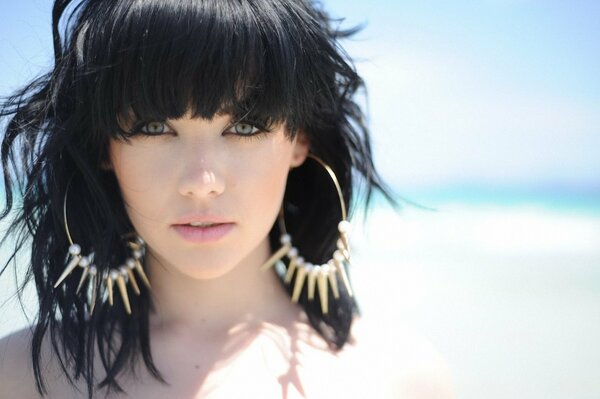 Brunette girl with large earrings portrait bangs