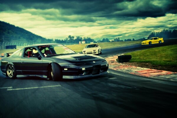 Racing on the track. In the foreground is a drifting Nissan