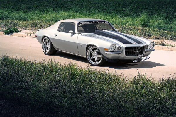 Silver Chevrolet on a sandy road