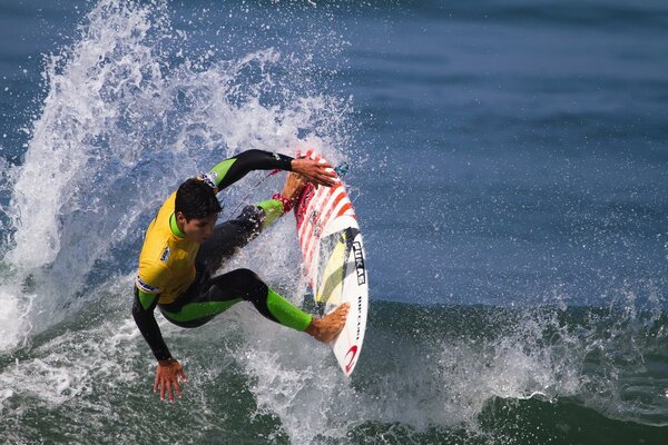 The guy on the board is rushing through the waves