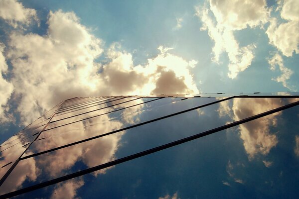 Glass building in white clouds