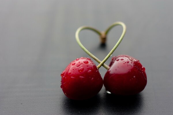 Two cherries and a heart symbol