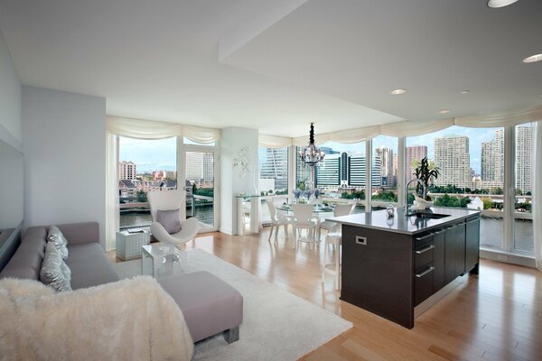 Apartment with a laconic design in white tones with a view of the city