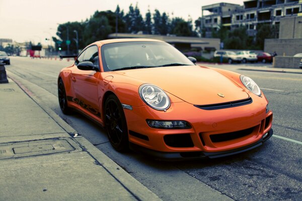 Porsche naranja en el fondo de la calle