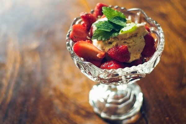 Strawberry dessert with mint in a cream bowl