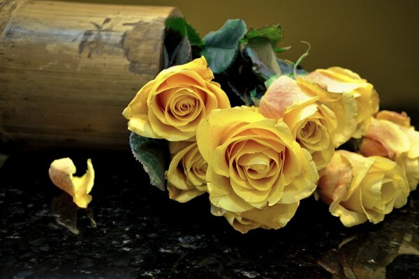 Żółte róże w drewnianej beczce