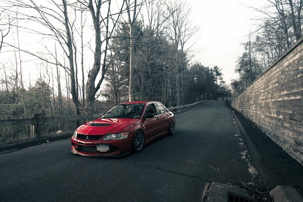 Mitsubishi lancer evo on a dull gray road