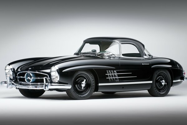 There is a classic car on a black and white background