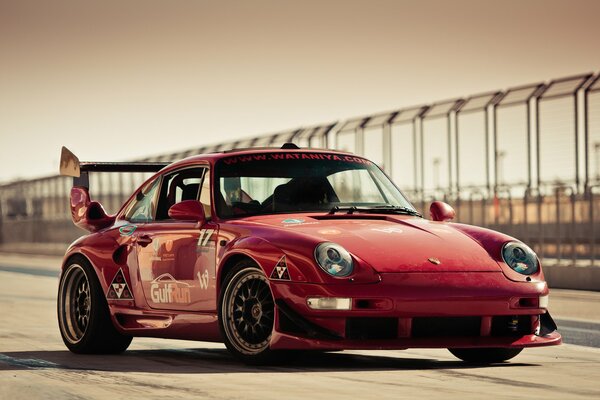 Red Porsche gt600 on the race track
