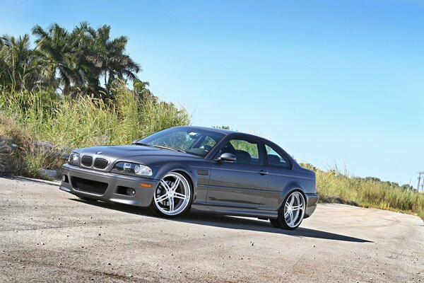 BMW M3 E46 grey is standing in the middle of the road on a sunny day
