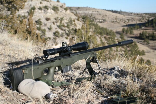 L96 sniper rifle on the background of hills