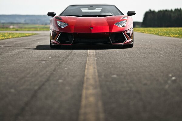 Czerwone Lamborghini na utwardzonej drodze