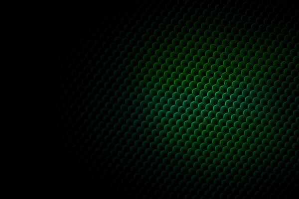 Texture of green scales with a transition to a black gradient
