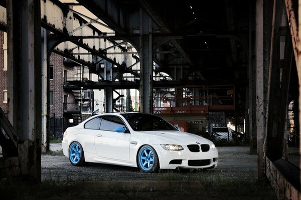 White bmw on the bridge in front of city buildings
