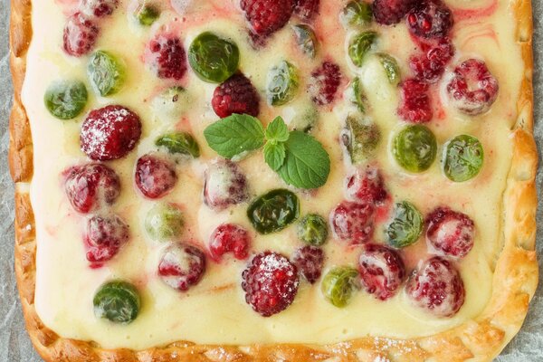 Hot pie with wild berries and a sprig of mint