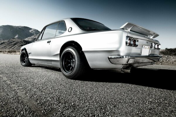 White Nissan on a gravel road