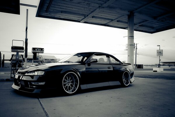 Black Nissan Silvia s14 at the gas station retro style