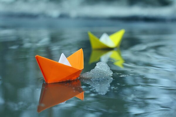 Paper boats float on the water