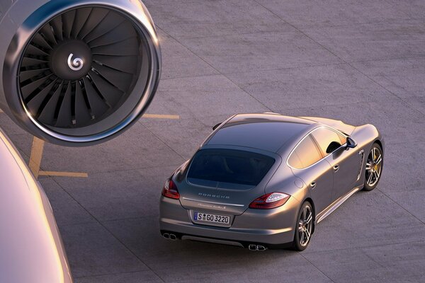 A car on the runway near the plane