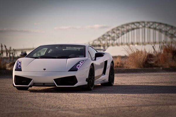 There is a car on the road against the background of the bridge